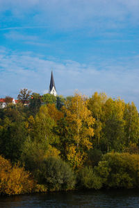 Scenic view of trees against cloudy sky