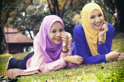 Portrait of a smiling girl sitting outdoors