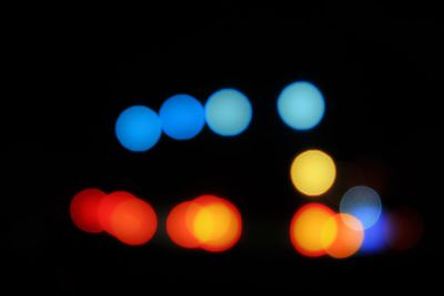 Defocused image of illuminated colorful lights at night