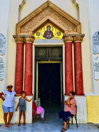 Full length of people in front of traditional building