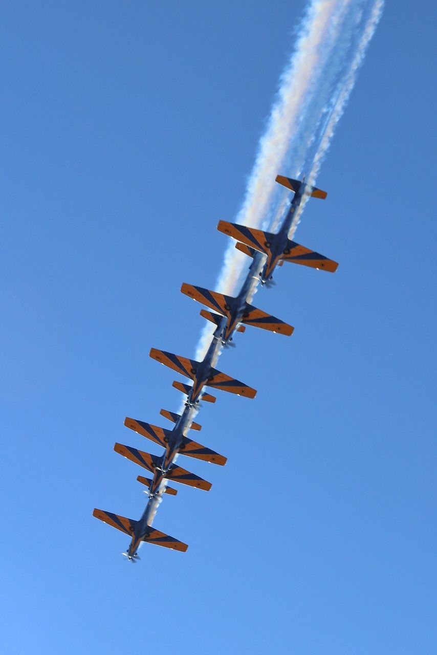 air vehicle, sky, airplane, low angle view, on the move, mode of transportation, transportation, motion, flying, clear sky, vapor trail, airshow, blue, nature, smoke - physical structure, speed, no people, mid-air, day, copy space, teamwork, plane, outdoors, aerobatics, aerospace industry, directly below