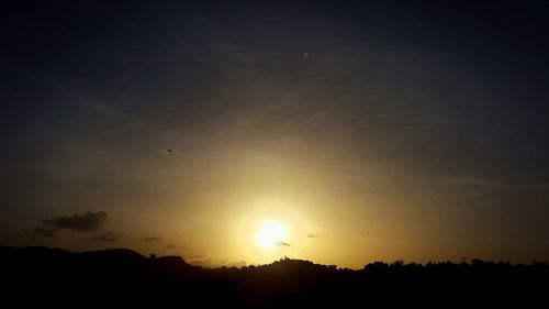 Silhouette trees against sky during sunset