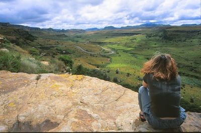 Rear view of woman looking at mountain landscape