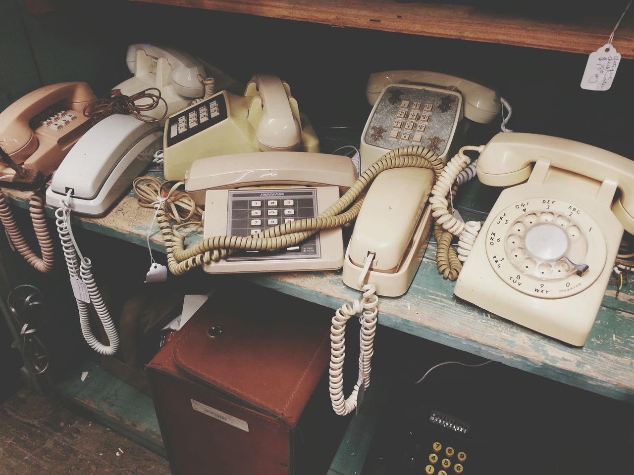 indoors, text, communication, western script, technology, close-up, still life, retro styled, number, old-fashioned, table, antique, metal, telephone, connection, no people, old, high angle view, music, equipment