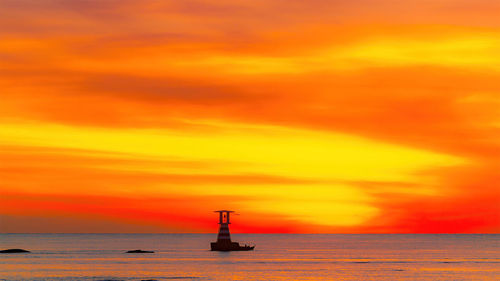 Scenic view of sea against orange sky
