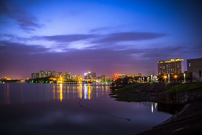 Reflection of illuminated buildings in water at dusk