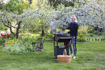 Woman making barbecue at backyard