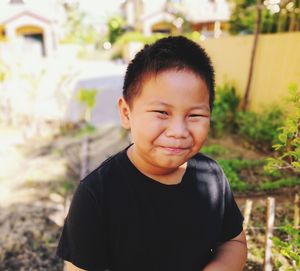 Portrait of smiling boy against plants