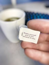 Close-up of hand holding coffee cup