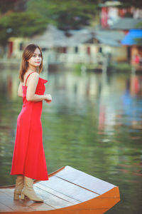 Asian woman wearing cheongsam traditional red dress on chinese new year travel.