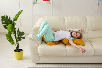 Boy relaxing on sofa at home