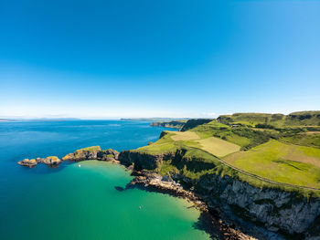 Scenic view of sea against clear blue sky