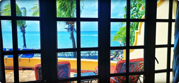 Scenic view of sea seen through glass window