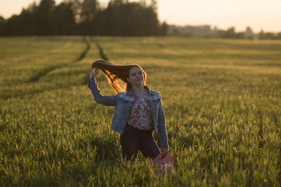 Portrait of woman standing on field