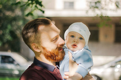Portrait of father with baby outdoors