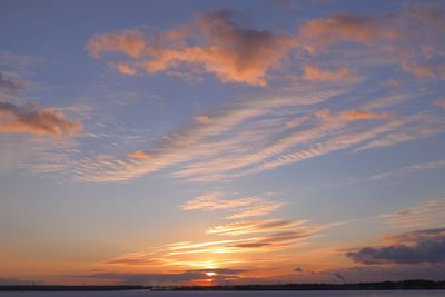 Low angle view of dramatic sky over sea during sunset