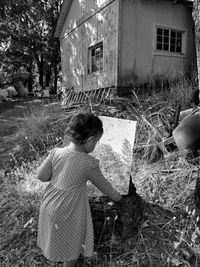 Full length of girl standing by building