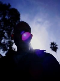 Low angle portrait of silhouette man against sky during sunset