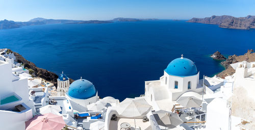 View of santorini with typical blue dome church, sea and santorini caldera