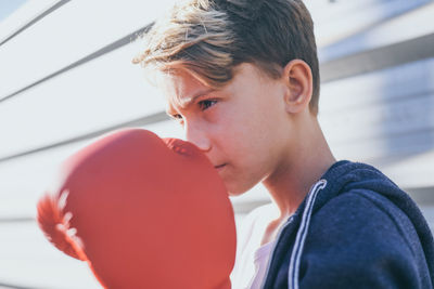 Close-up of boy wearing boxing glove