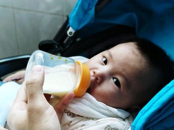Close-up portrait of cute boy holding drink