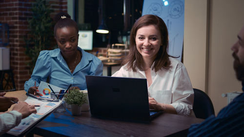 Portrait of woman using laptop at table