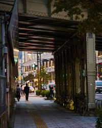 Rear view of man walking on street in city