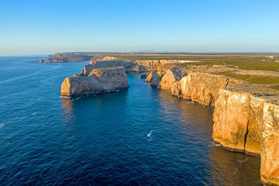 Scenic view of sea against clear blue sky