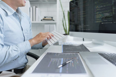 Software development concept, male programmer using keyboard to typing data codes on computer.