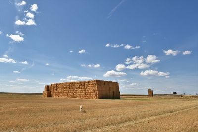 Built structure on field against sky