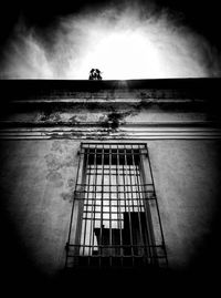 Low angle view of silhouette building against sky