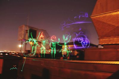 Low angle view of illuminated lights at night