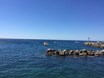 Scenic view of sea against clear blue sky