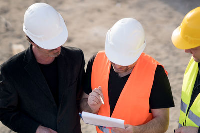 Construction workers communicating at site