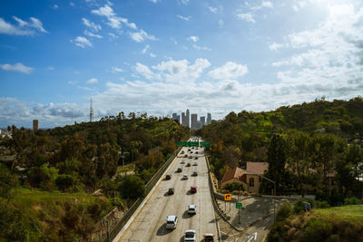 High angle view of street amidst trees against sky