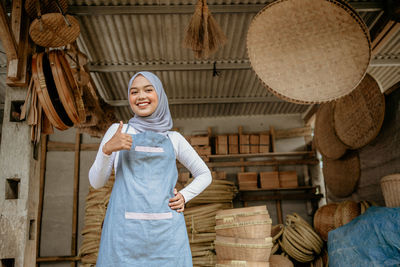 Portrait of young woman standing at market