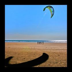 Scenic view of beach against blue sky