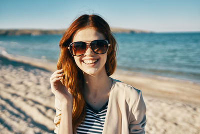 Portrait of smiling young woman on beach