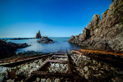 Scenic view of sea against clear sky at night