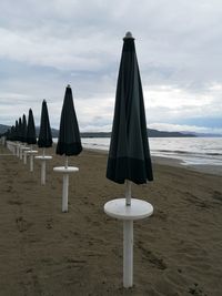 Lifeguard hut on beach against sky