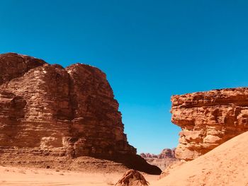 Rock formations against clear blue sky