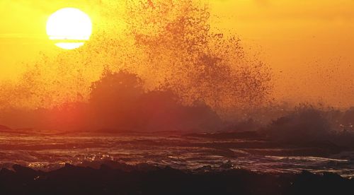 Scenic view of sea against clear sky during sunset