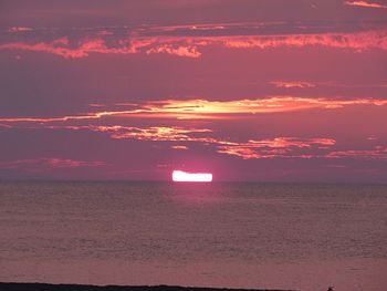 Scenic view of sea against romantic sky at sunset