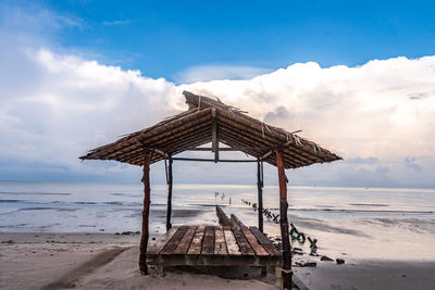 Lifeguard hut on beach against sky