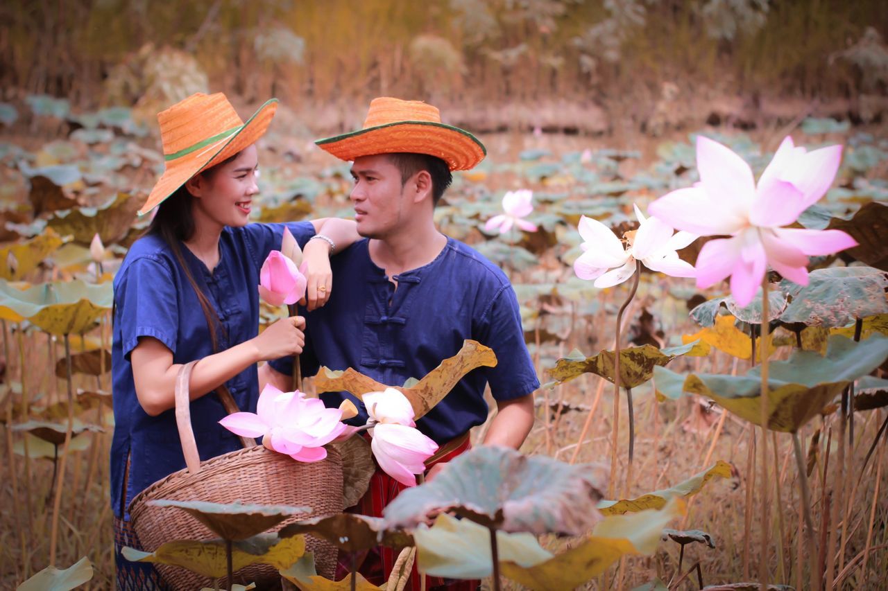 child, real people, boys, childhood, plant, men, males, casual clothing, leisure activity, nature, holding, day, hat, flower, people, front view, lifestyles, flowering plant, two people, outdoors, pre-adolescent child