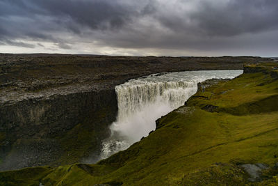 Scenic view of waterfall against sky