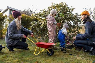 Happy family doing gardening together at back yard