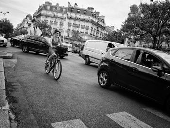 Cars on road against sky in city