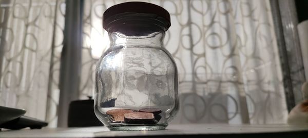 Close-up of glass jar on table at home