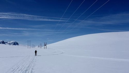 People standing on snow covered landscape